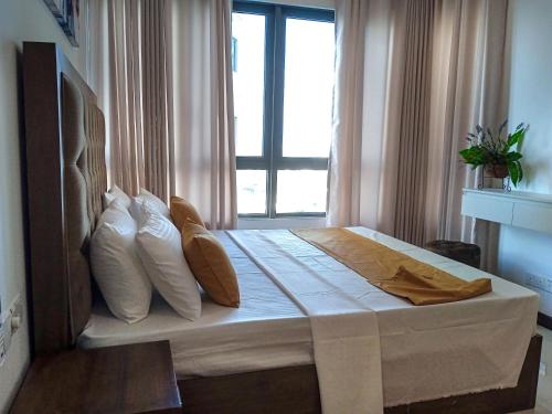 a bed in a room with a window at Colombo, Trizen Luxury Apartments, Sri Lanka in Colombo