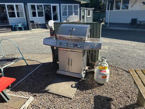 a grill sitting on the side of a street at Westshore Holiday Park in Napier
