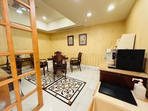 a waiting room with a table and chairs at Royal Seasons Hotel Taipei ‧ Nanjing W. in Taipei