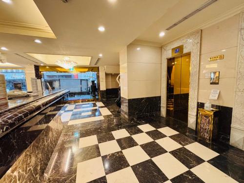 a lobby with a checkered floor in a building at Royal Seasons Hotel Taipei ‧ Nanjing W. in Taipei