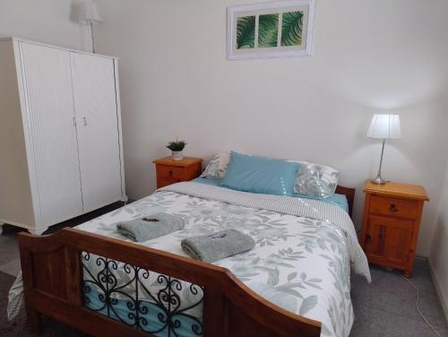 a bedroom with a bed with two towels on it at Corella Accommodation 1A in Boulder