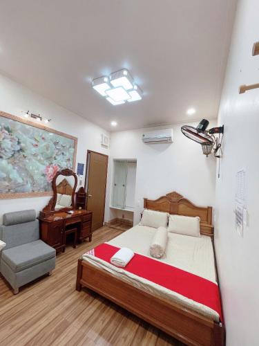 a bedroom with a bed and a chair and a desk at Duy Anh Hotel Biên Hoà in Bien Hoa