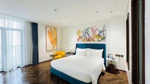 a hotel room with a bed and a large window at Belliss Hotel And Spa Dai Lai in Phúc Yên