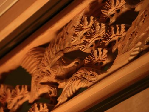 a wooden carving of a dragon on a wall at Azumino Salon in Azumino