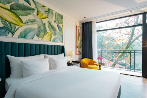 a bedroom with a large bed and a large window at Belliss Hotel And Spa Dai Lai in Phúc Yên