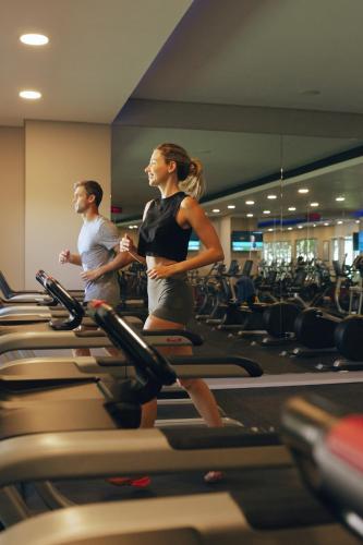 a man and woman standing on treadles in a gym at Sugar Beach Mauritius in Flic-en-Flac