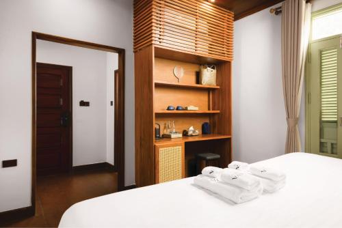 Nava Luang Prabang Hotelにあるベッド
