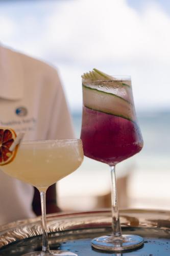 two cocktails sitting on top of a tray at Sugar Beach Mauritius in Flic-en-Flac