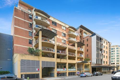 an apartment building with balconies on a city street at Spacious 2-Bed Apartment Near Parramatta CBD in Sydney