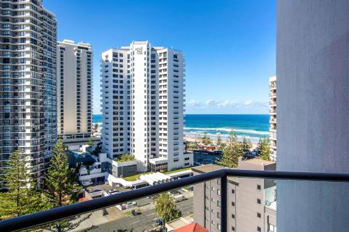 a view of a city with buildings and the ocean at Comfortable Hotel Studio at Legends Resort - CoastHM in Gold Coast