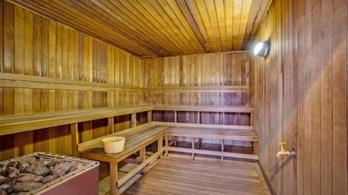 an empty wooden sauna with a wooden table in it at Comfortable Hotel Studio at Legends Resort - CoastHM in Gold Coast