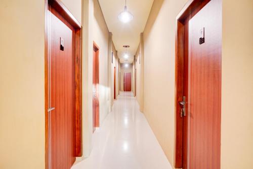 a corridor of a hospital with two doors at Collection O Padang City Center Near Transmart Padang Formerly De Orchids in Padang