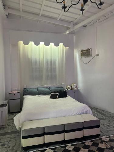 a bedroom with a large bed with a laptop on it at Casa Felice in Legazpi
