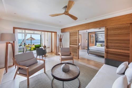 a living room with a couch and a table at Sugar Beach Mauritius in Flic-en-Flac