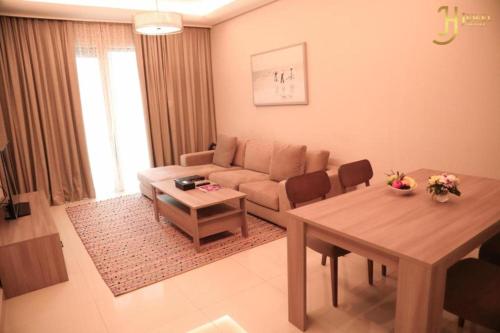 a living room with a couch and a table at Dancenter Jewel Near World Trade Center in Manama