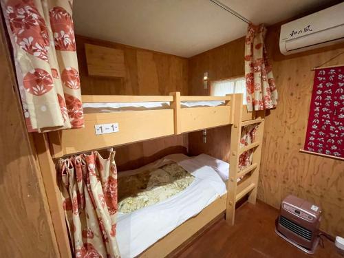 a bedroom with two bunk beds in a room at Guesthouse Otaru Wanokaze women's domitory / Vacation STAY 32191 in Otaru