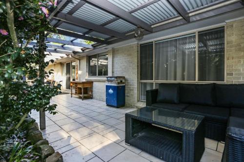 a screened in patio with a couch and a table at Vitamin Sea Pet Friendly in Hawks Nest