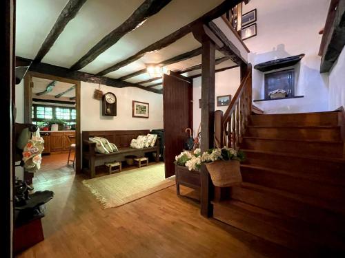 a living room with a staircase in a house at Casa rural Garata in Arantza