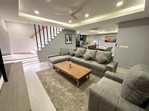 a living room with a couch and a table at Super Luxury 3 Bedroom Private Pool Villa with Jacuzzi, Near 711, 10 minutes to Walking Street and Pattaya Beach - MT8 in Pattaya