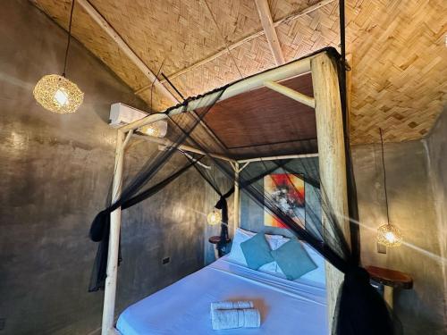 a bedroom with a canopy bed in a tent at Carabao Lodge - 2 bedroom house with AC & plunge pool in El Nido