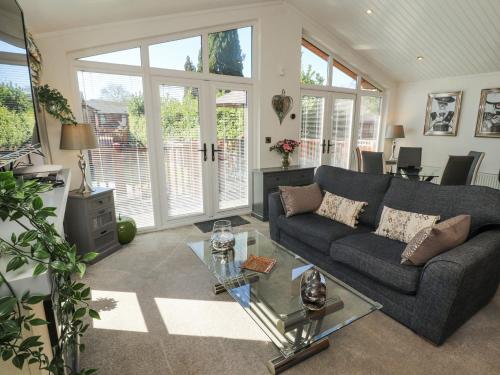 a living room with a couch and a table at Bowness 66 in Windermere