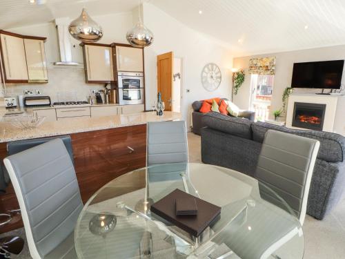 a kitchen and living room with a glass table at Bowness 66 in Windermere