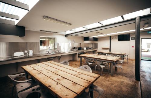 a large kitchen with wooden tables and chairs at Margaret River Tourist Park in Margaret River Town