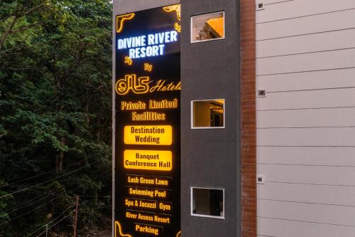 a sign for a wine river resort on the side of a building at DLS Divine River Resort and Spa, Rishikesh in Rishīkesh