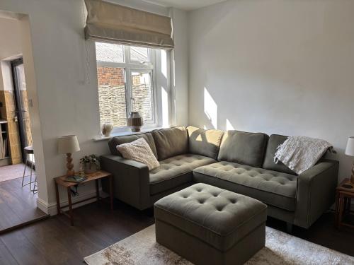 a living room with a couch and a table at 9 Portland Street in Leek