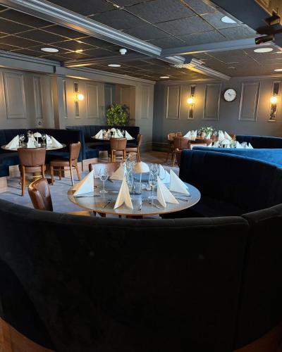 a dining room with a table and chairs and tablesktop at Central Hotellet Tierp in Tierp