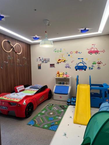 a childs bedroom with a red toy car on the wall at Gloucester Hotel Incheon in Incheon