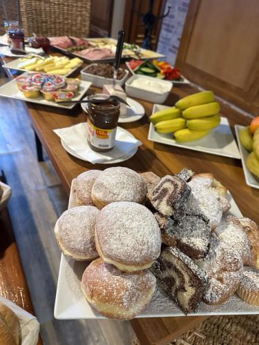 a table topped with different types of donuts on plates at Restaurace Stará Lípa in Česká Lípa