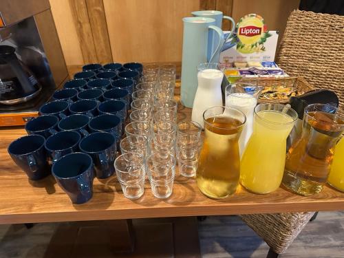 a table with glasses and pitchers of drinks on it at Restaurace Stará Lípa in Česká Lípa