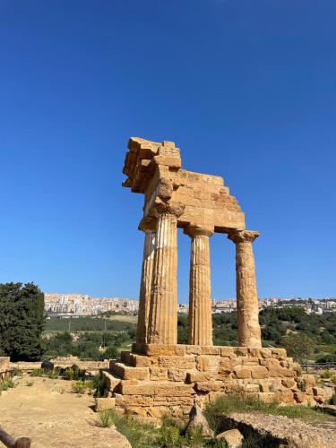 an ancient monument in the middle of a field at Sikelia Suite Rooftop in Porto Empedocle