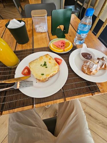 a person sitting at a table with plates of food at Grand Plaza in Nouakchott