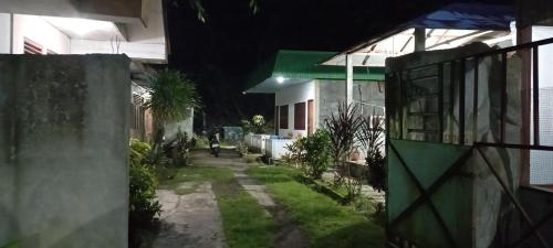 a courtyard of a house at night at MamaRoos Reborn Home Stay in Rinondoran