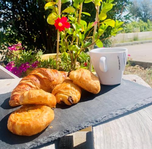 a tray with croissants and a cup of coffee on a table at Audotel in Carcassonne