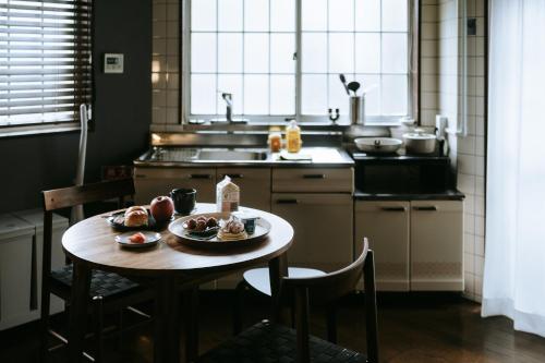 a kitchen with a table with a plate of food on it at 大正車站4分陽当たり良い貸切一軒家 in Osaka