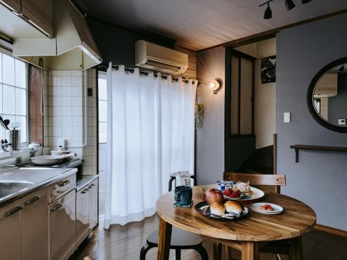a kitchen with a wooden table with fruit on it at 大正車站4分陽当たり良い貸切一軒家 in Osaka