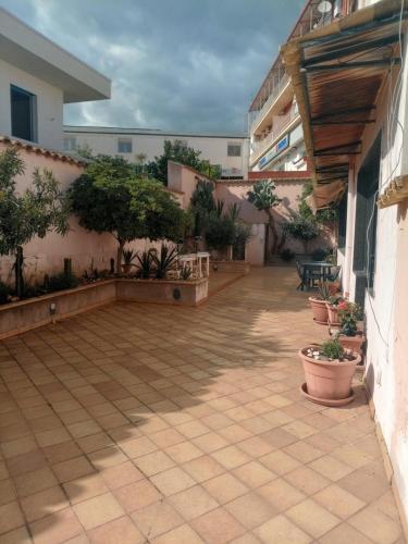 a courtyard of a building with trees and plants at Casa di Luca in Agrigento