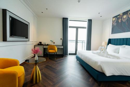 a hotel room with a large bed and a tv at Belliss Hotel And Spa Dai Lai in Phúc Yên
