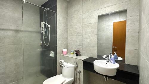 a bathroom with a toilet and a sink and a shower at 2BR Lively City View Family Suite#Airport in Bayan Lepas