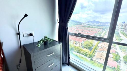 a room with a dresser and a large window at 2BR Lively City View Family Suite#Airport in Bayan Lepas