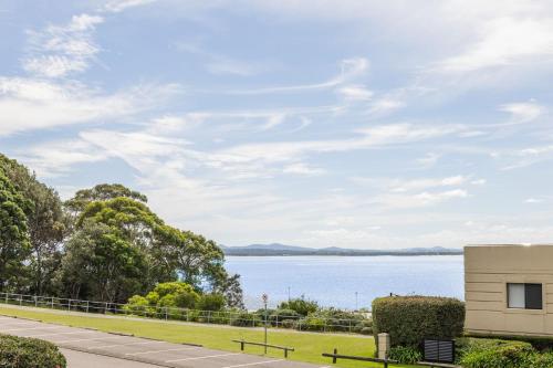 a house with a view of a lake at Portofino, 1,7 Laman Street - First floor unit with beautiful views, air con and Wi-Fi and close to town in Nelson Bay