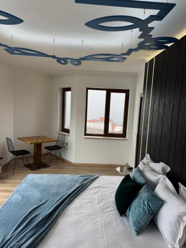 a bedroom with a bed with a blue ceiling at Queen's Penthouse Balchik apartment in Balchik