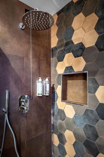 a bathroom with a shower with a shower head at Hotel Duomo Firenze in Florence