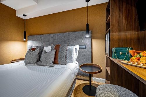 a bedroom with a bed and a counter with a plate of food at Hotel Duomo Firenze in Florence