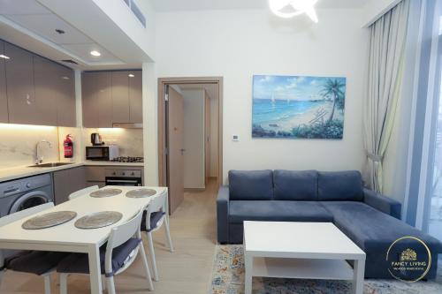 a living room with a couch and a table at Luxury 2-BHK Apartment Located in Azizi riviera 47 Riv 47-419 in Dubai