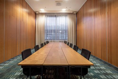 a conference room with a long table and chairs at Hilton Helsinki Airport in Vantaa