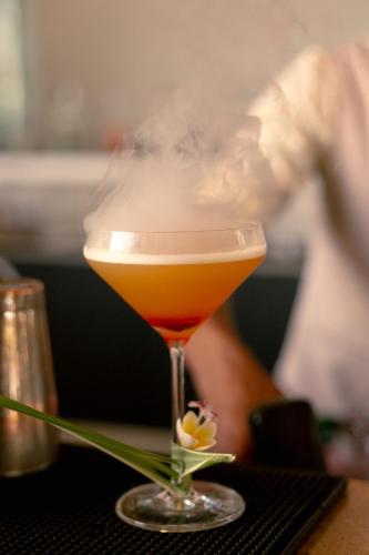 a drink in a glass sitting on a table at Ambre - Adults only in Belle Mare